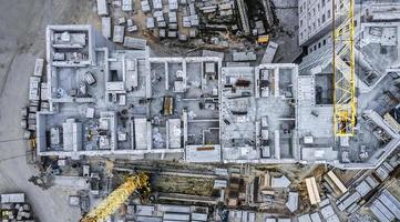 high building tower cranes near modern block apartments under construction. aerial view photo