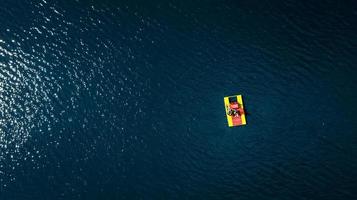 catamaran with people on the water top view photo