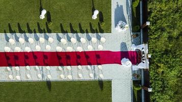 Beautiful outgoing wedding ceremony with red carpet top view photo