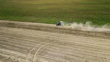 Tractor in a farmer field top view photo