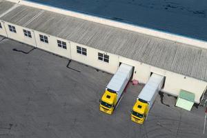 Loading trucks in a logistics center top view from a drone photo