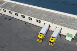 Loading trucks in a logistics center top view from a drone photo