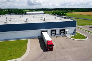 Aerial view of trucks parked in front of industry building. Aerial. photo