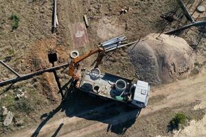 unloading concrete rings for the construction of wells and sewers top view photo