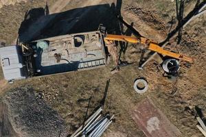 unloading concrete rings for the construction of wells and sewers top view photo