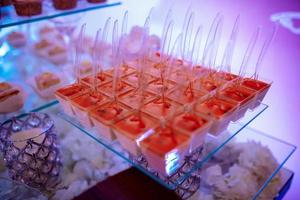 Candy bar on wedding ceremony with a lot of different cupcakes, modern desserts, mousses and jellies. selective focus photo