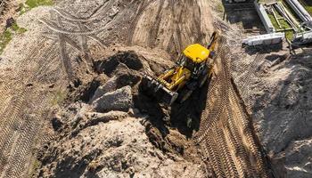 excavator working on a construction site top view photo