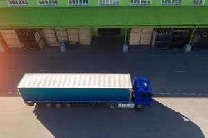 the truck is waiting to load at the factory top view