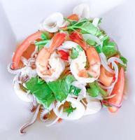 Spicy seafood salad,hot and spicy, seafood thai  isolated on the white background photo