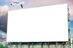 Large billboard white blank and airplane on sky photo