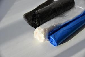 Plastic garbage bags in rolls on a white background photo