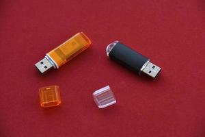 Various USB flash drives on a red background photo