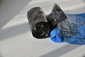 Plastic garbage bags in rolls on a white background photo