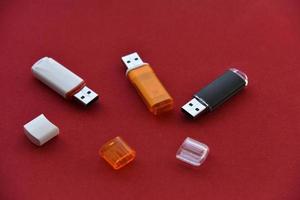 Various USB flash drives on a red background photo