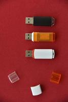 Various USB flash drives on a red background photo