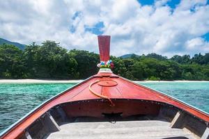 Front wood longtail boat and crystal sea with blue sky photo