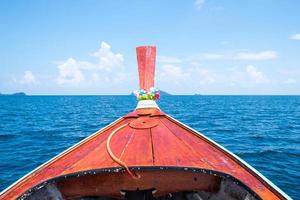 Front longtail boat and blue sea sky photo