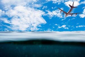 Underwater wave surface with airplane on sky photo