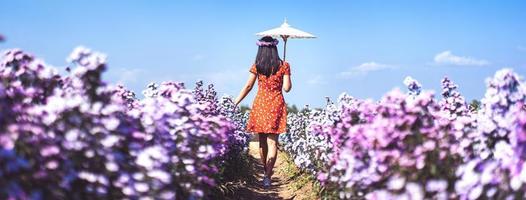 Travel adult woman walking relax in margaret flower field. photo