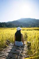 Solo traveller adult woman relax at rice field. photo