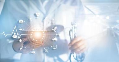 Medicine doctor and stethoscope in hand with icon medical network connection with modern virtual screen interfacein hospital background, medical technology network concept photo