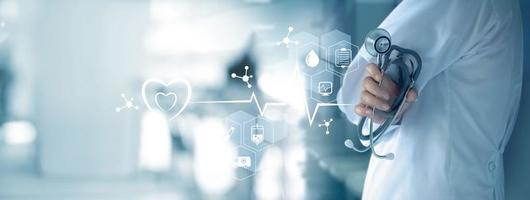 Medicine doctor with stethoscope in hand and icon medical network connection on  virtual screen interface. Modern medical technology and innovation concept photo