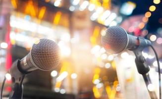 Microphones on stage in concert on lighting background photo