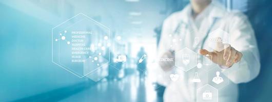 Medicine doctor and stethoscope touching icon medical network connection with modern virtual screen interface in hospital background. Medical technology network concept photo