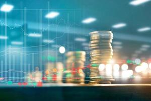 Finance and business investment concept. Graph and rows with statistic growth of coins on table. photo