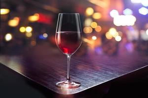 Wine glass on the colorful bar background photo