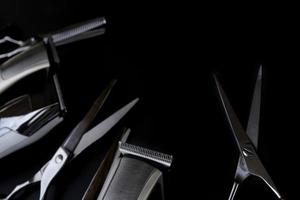 A set of hair cut tools on black background for cutting barber beard salon photo