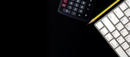 Concept of finance, documents and office supplies on black background. Flatlay, Top view with copy space, Banner background photo