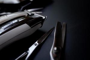 A set of hair cut tools on black background for cutting barber beard salon photo