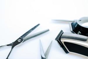 Professional barber's hair cutting tools set on white background. photo