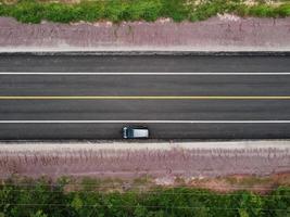 Top view of a country road with cars parked on the side of the road, drone aerial shot photo