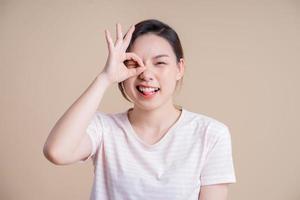 Portrait of young Asian girl posing on background photo