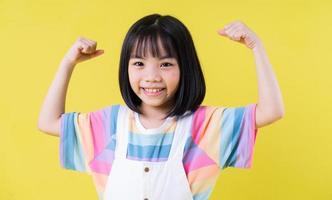 Portrait of Asian child on yellow background photo