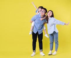 Full length image of young Asian family on background photo