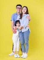 Full length image of young Asian family on background photo