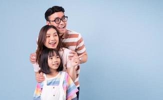 Portrait of young Asian family on background photo