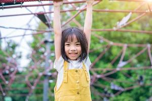 Asian child playing at park photo