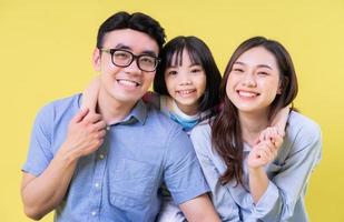 Portrait of young Asian family on background photo