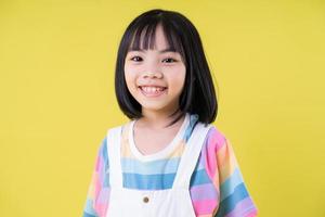 Portrait of Asian child on yellow background photo