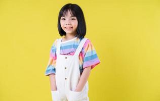 Portrait of Asian child on yellow background photo