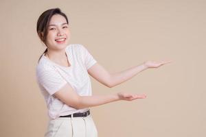 Portrait of young Asian girl posing on background photo