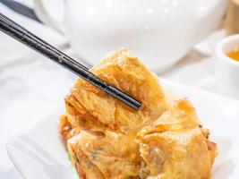Delicious dim sum, famous cantonese food in asia - Fried bean curd tofu skin rolls with shrimp and prawn in hong kong yumcha restaurant, close up photo