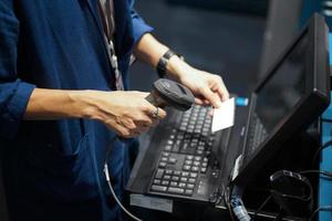 Point of sales shot, barcode or QR code scanning front of computer. photo