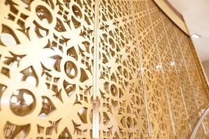 the Golden craft Thai pattern popup on the wall backdrop in some place at Thailand. photo