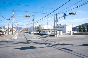 Japanese junction with traffic light and pole and electric cable, but without a car on the street photo