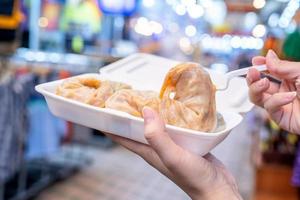 Delicious steamed round shaped dumplings in South Korea traditional market, special korean street food cuisine, close up, bokeh, copy space photo